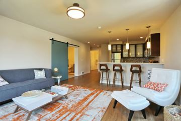 Seattle apartment for rent - a living room with a couch and a kitchen with a bar