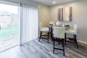 Owings Mills townhouse for rent - a dining room with a table and chairs and a sliding glass door