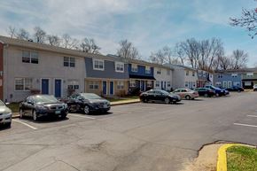 Owings Mills townhouse for rent - a parking lot filled with cars in front of apartment buildings