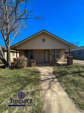 Abilene house for rent - A house with Impact Realty logo on the grass.