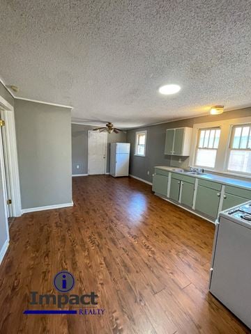 Abilene house for rent - A kitchen with wood floors and a refrigerator.