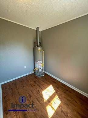 Abilene house for rent - A room with a wood floor and a wall-mounted heater.