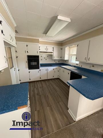 Abilene house for rent - A kitchen with white cabinets and a blue counter.