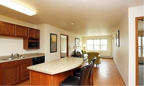Cedar Rapids apartment for rent - A kitchen with wooden cabinets and a white countertop.