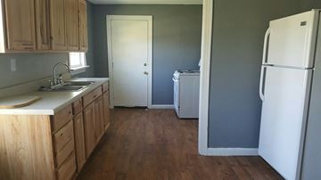 Abilene house for rent - an empty kitchen with a refrigerator and a sink