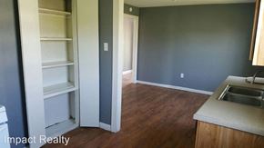 Abilene house for rent - a kitchen and a living room with a sink and cabinets