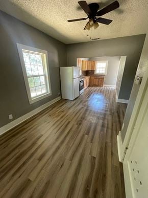 Abilene house for rent - an empty living room with wood floors and a kitchen