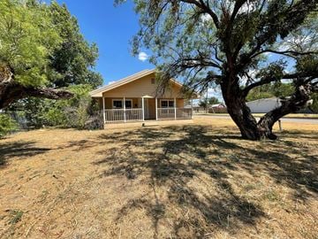 Abilene house for rent - a small house with a tree in front of it