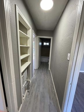Abilene house for rent - A long hallway with a door on the right and a pantry on the left.