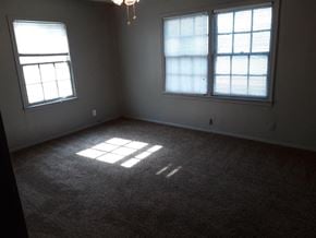 Abilene house for rent - an empty living room with two windows