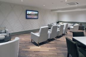 Peekskill apartment for rent - a dining room with chairs and tables and a tv on the wall
