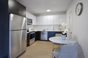 Peekskill apartment for rent - a kitchen with stainless steel appliances and a table and chairs