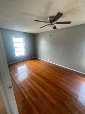 Abilene house for rent - an empty room with wooden floors and a ceiling fan