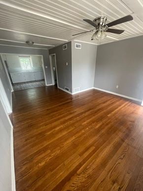 Abilene house for rent - an empty living room with wooden floors and a ceiling fan