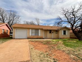 Abilene house for rent - A house with a brown roof and a white garage door.
