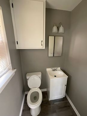 Abilene house for rent - A white toilet and sink in a small bathroom.