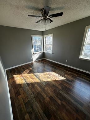 Abilene house for rent - an empty living room with wooden floors and a ceiling fan