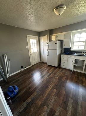 Abilene house for rent - a kitchen with a hard wood floor and a refrigerator