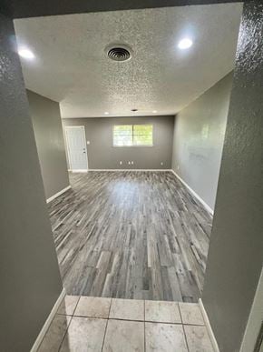 Abilene apartment for rent - a empty living room with wood floors and grey walls