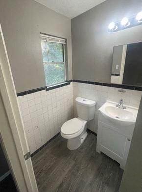Abilene house for rent - a white bathroom with a toilet and a sink