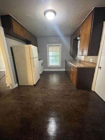 Abilene house for rent - an empty kitchen with a refrigerator and a sink