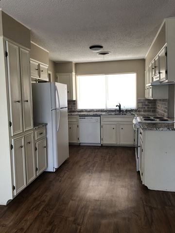 Abilene house for rent - an empty kitchen with white cabinets and stainless steel appliances