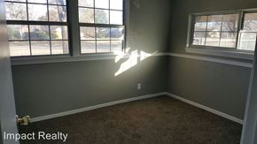 Abilene house for rent - an empty room with three windows and a carpet