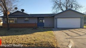 Abilene house for rent - the front of a house with a driveway and a blue door
