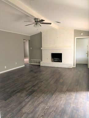 Abilene house for rent - A room with a fireplace and a ceiling fan.