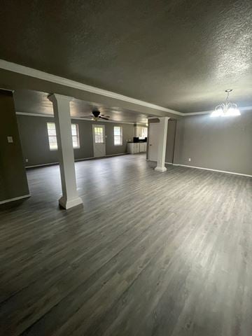 Abilene house for rent - A spacious room with wooden flooring and a ceiling fan.