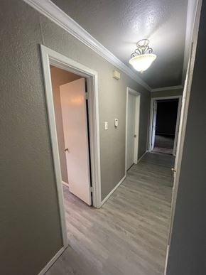 Abilene house for rent - A hallway with a light on and a door open.