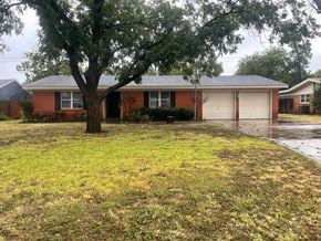 Abilene house for rent - A house with a tree in front of it.