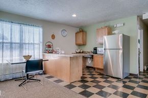 Copenhagen apartment for rent - a kitchen with a checkered floor and a refrigerator