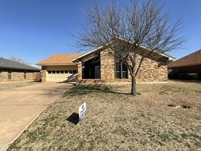 Abilene house for rent - a brick house with a tree in front of it