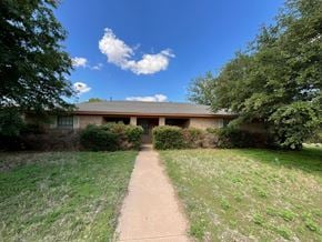Abilene house for rent - A house with a brown roof and a green lawn in front.