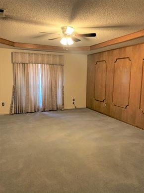 Abilene house for rent - an empty living room with curtains and a ceiling fan