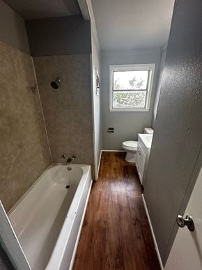 Abilene house for rent - A bathroom with a tub and toilet.