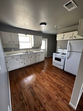 Abilene house for rent - A kitchen with white appliances and wooden floors.