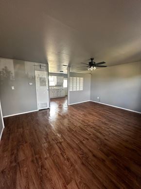 Abilene house for rent - A room with wooden flooring and a ceiling fan.