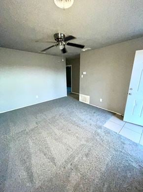 Abilene house for rent - an empty living room with carpet and a ceiling fan