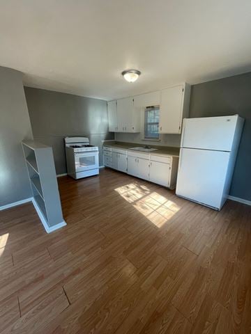 Abilene apartment for rent - an empty kitchen with wood floors and white appliances