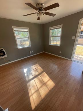 Abilene apartment for rent - an empty living room with wooden floors and a ceiling fan