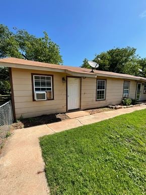 Abilene apartment for rent - a small tan house with a driveway and a lawn