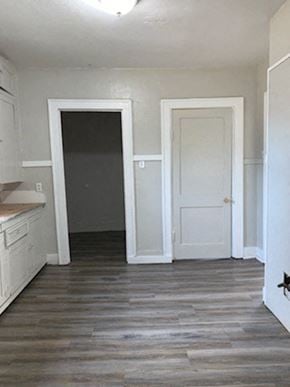 Abilene apartment for rent - A kitchen with white cabinets and a black door.