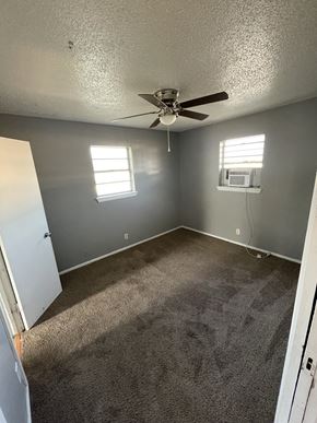 Abilene apartment for rent - an empty room with carpet and a ceiling fan