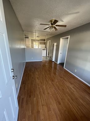 Abilene apartment for rent - an empty living room with wood floors and a ceiling fan