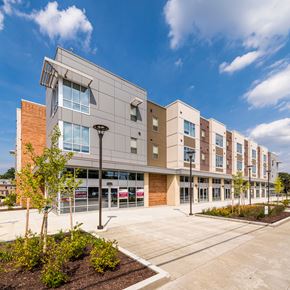 Cincinnati apartment for rent - an exterior view of a building with a parking lot