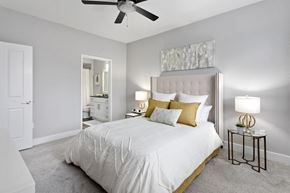 Scottsdale apartment for rent - a bedroom with a large bed and a ceiling fan