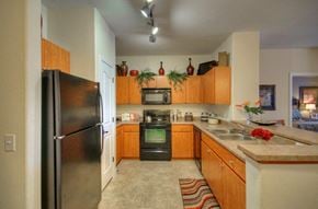 Peoria apartment for rent - Vue Park West Kitchen with black appliances and brown cabinets