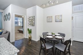 Austin apartment for rent - A dining room with a table set for two and a couch.